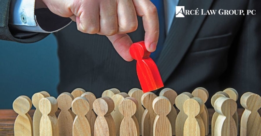 Wooden people with one red person